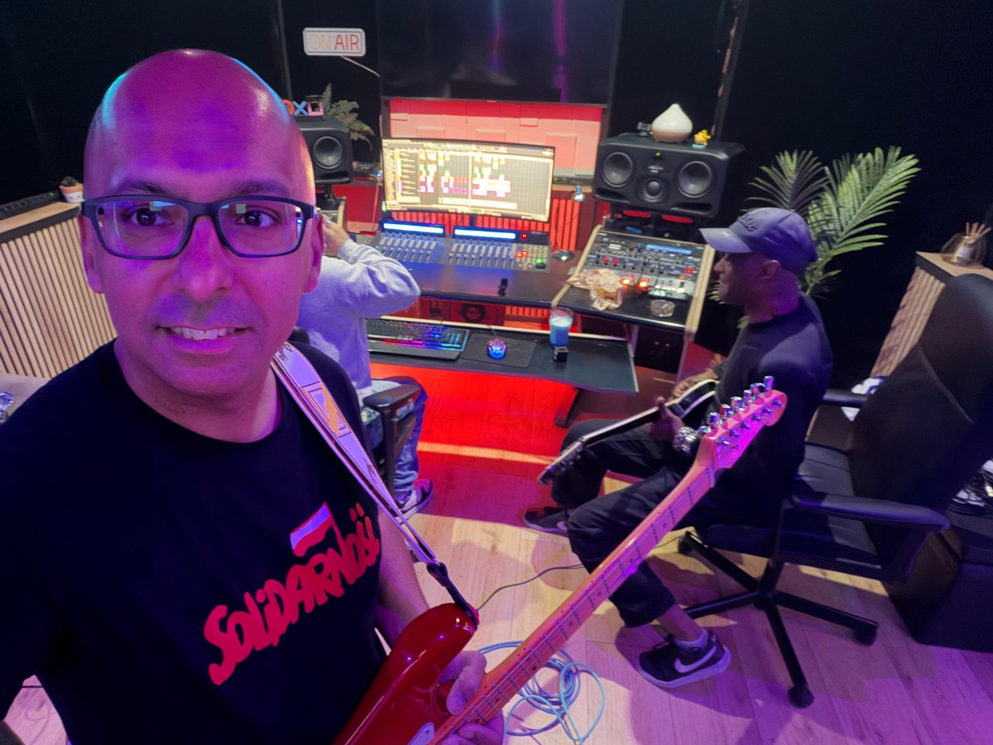 David Chung with a guitar in the music studio