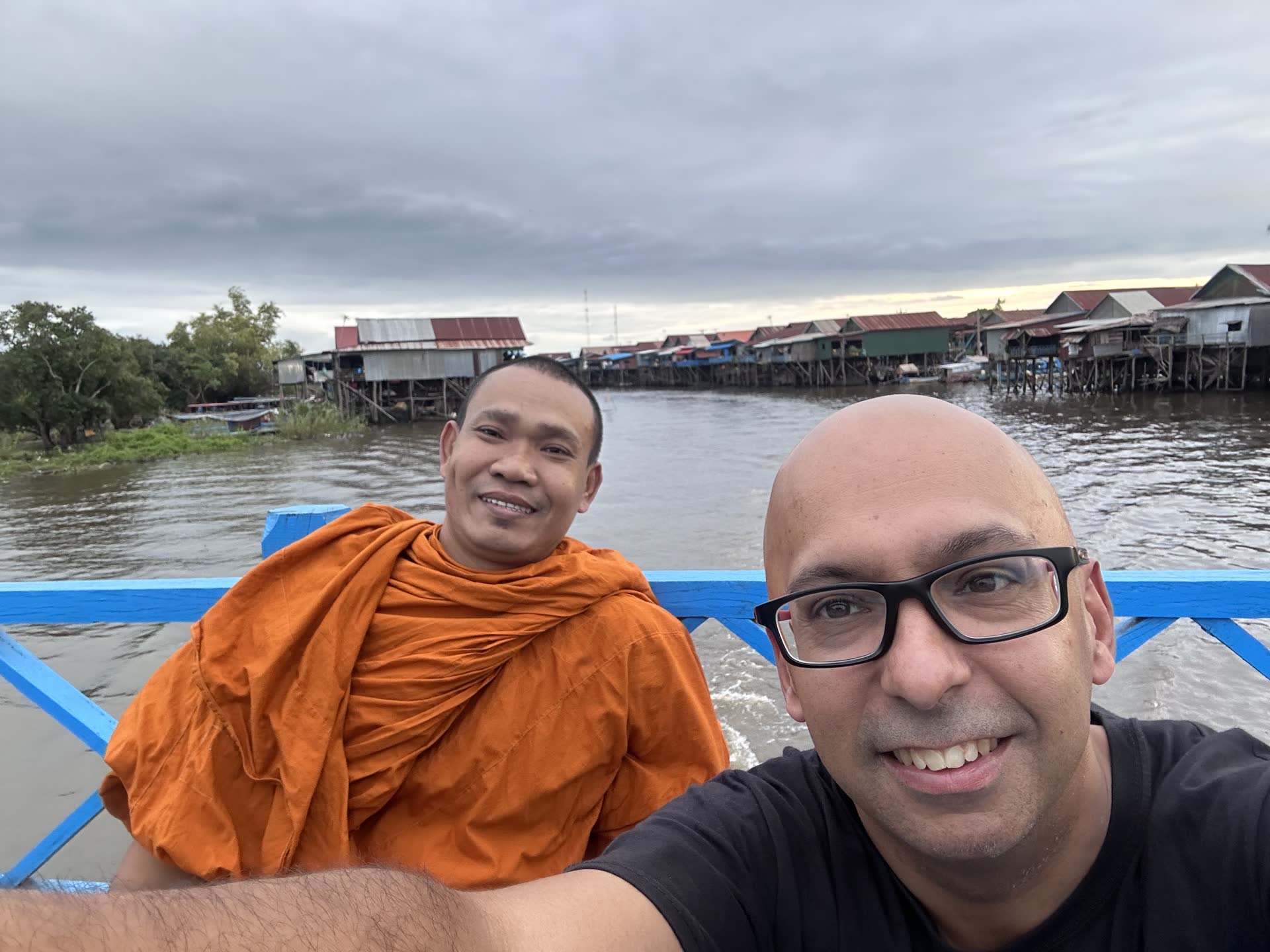 David Chung with a monk at a floating village in Cambodia