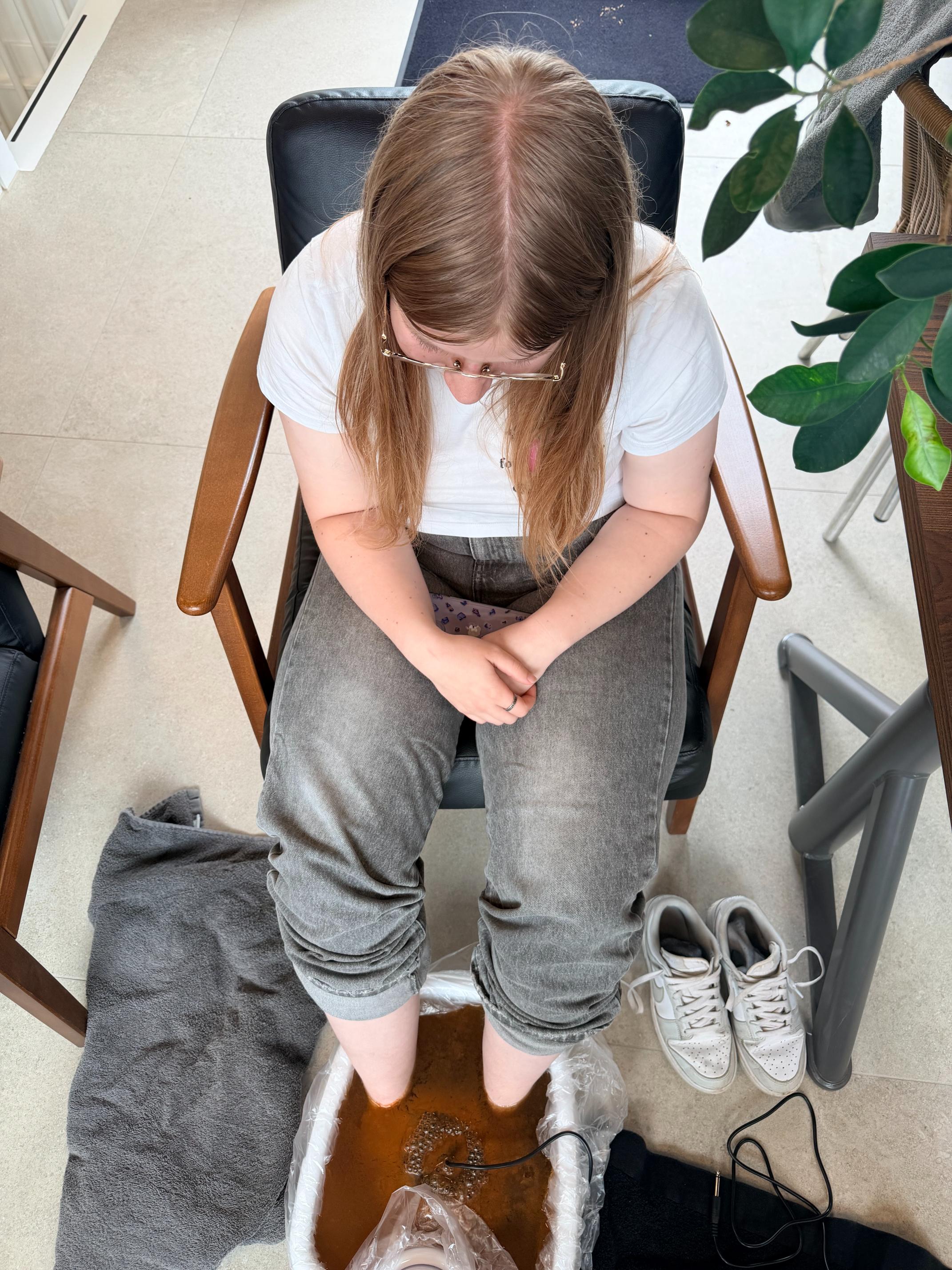 Employee with their feet in the detox foot bath